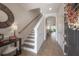 Welcoming foyer with staircase, tiled floor, and views into the living and dining area at 1002 Vineyard Ln, Oldsmar, FL 34677