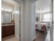 Hallway leading to Primary bathroom and bedroom with neutral colors and wood flooring at 1002 Vineyard Ln, Oldsmar, FL 34677