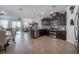 Open concept kitchen with dark wood cabinetry, stainless steel appliances, and view to the living area at 1002 Vineyard Ln, Oldsmar, FL 34677