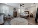 The main bedroom features a decorative rug, ceiling fan and lots of natural light at 1002 Vineyard Ln, Oldsmar, FL 34677