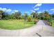 Scenic view of a concrete walking trail leading to a charming wooden bridge surrounded by a lush green landscape at 1002 Vineyard Ln, Oldsmar, FL 34677