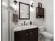 Bathroom with dark wood vanity, marble countertop, and updated fixtures at 114 27Th N Ave, St Petersburg, FL 33704