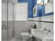 Bright, clean bathroom features classic black and white tile, with blue accent wall at 114 27Th N Ave, St Petersburg, FL 33704