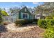 Beautiful home featuring lush greenery, a white picket fence, and stone pathway at 114 27Th N Ave, St Petersburg, FL 33704