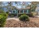 Quaint home exterior with a charming garden, lush foliage, and arched entryway at 114 27Th N Ave, St Petersburg, FL 33704