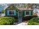 Charming home featuring teal shutters, lush landscaping, and well-maintained front yard at 114 27Th N Ave, St Petersburg, FL 33704