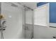 This modern glass enclosed shower has a built in bench and a shower wand at 114 27Th N Ave, St Petersburg, FL 33704