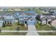 Aerial view of blue two story house with pond view in an established neighborhood with mature trees at 11938 Bahia Valley Dr, Riverview, FL 33579