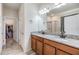 Bathroom with double sink vanity with granite countertop, a large mirror, and a separate shower at 11938 Bahia Valley Dr, Riverview, FL 33579