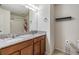 Bathroom featuring double sinks with granite countertops and framed mirrors with decorative lighting at 11938 Bahia Valley Dr, Riverview, FL 33579