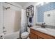 Bright bathroom with a tiled shower, patterned accent wall, and granite countertop at 11938 Bahia Valley Dr, Riverview, FL 33579