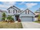 Lovely two-story blue home with a two-car garage and manicured front lawn at 11938 Bahia Valley Dr, Riverview, FL 33579