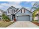 Two story blue home with garage and manicured lawn with fresh mulch and new landscaping at 11938 Bahia Valley Dr, Riverview, FL 33579