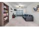 Cozy living room featuring a comfortable sofa, ceiling fan, and built-in shelving at 11938 Bahia Valley Dr, Riverview, FL 33579