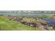 Picture of a pond with a grassy bank, aquatic plants and a view of houses across the water at 11938 Bahia Valley Dr, Riverview, FL 33579