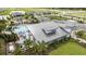 Overhead view of the community clubhouse with a pool, playground, lush landscaping, and surrounding residential area at 12316 49Th E St, Parrish, FL 34219