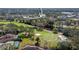 Aerial view of condo building with golf course, trees, and well-maintained landscaping at 129 W Cypress Ct, Oldsmar, FL 34677