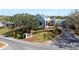 Exterior view of the community clubhouse, featuring manicured landscaping and visible signage at 129 W Cypress Ct, Oldsmar, FL 34677