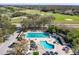 Aerial view of the community pool, with a large swimming pool and kid-friendly splash pool at 129 W Cypress Ct, Oldsmar, FL 34677