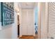 Hallway features wood-look floors and a closet, leading to a bathroom and bedroom at 129 W Cypress Ct, Oldsmar, FL 34677