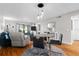 Bright living room featuring dining area, wood floors, comfortable seating, and sliding glass doors at 129 W Cypress Ct, Oldsmar, FL 34677