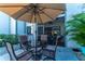 Enjoy outdoor dining on this condo's patio with a table, seating, and large umbrella at 129 W Cypress Ct, Oldsmar, FL 34677