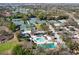 Aerial view showcasing a community pool with ample seating, complemented by a nearby recreational building at 129 W Cypress Ct, Oldsmar, FL 34677