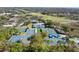 Overhead shot of multiple tennis courts, enhanced by blue canopies, providing a vibrant and shaded recreational space at 129 W Cypress Ct, Oldsmar, FL 34677