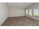 Well-lit bedroom featuring plank flooring, neutral paint and sunny windows at 13022 Wellspring Dr, Lithia, FL 33547