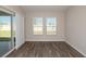 Bright living room featuring wood-look floors, natural light and sliding glass doors to covered patio at 13022 Wellspring Dr, Lithia, FL 33547