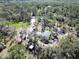 Aerial view of property with lush trees, pond, outbuilding and equipment at 13215 Seminole Trl, Wimauma, FL 33598