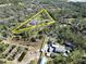 Aerial view of property shows the property's boundaries and its surrounding trees at 13215 Seminole Trl, Wimauma, FL 33598