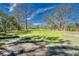 Expansive, partially cleared land with mature trees and blue skies offers tranquil country living at 13215 Seminole Trl, Wimauma, FL 33598