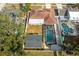 Aerial view of backyard featuring a screened pool, patio area, and privacy fence at 13508 Greenleaf Dr, Tampa, FL 33613