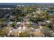 Wide angle real estate aerial view showing street and lakes in the distance with mature trees at 13508 Greenleaf Dr, Tampa, FL 33613