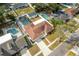 Wide aerial view of home with screened pool, surrounded by well-maintained landscaping and neighboring properties at 13508 Greenleaf Dr, Tampa, FL 33613