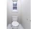 Small bathroom featuring a white toilet and a small frosted glass window at 13508 Greenleaf Dr, Tampa, FL 33613