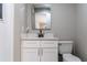 Small bathroom featuring a white vanity with quartz countertop and updated fixtures at 13508 Greenleaf Dr, Tampa, FL 33613