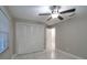 Bedroom featuring a ceiling fan, closet, and stylish flooring, offering a modern and comfortable living space at 13508 Greenleaf Dr, Tampa, FL 33613