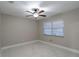 Bright bedroom with a ceiling fan and a bright window, complemented by modern, marble-look flooring at 13508 Greenleaf Dr, Tampa, FL 33613