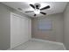 Bedroom featuring a ceiling fan, bright window, and closet, creating a practical and comfortable living space at 13508 Greenleaf Dr, Tampa, FL 33613