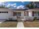 Charming single-story home featuring a white brick facade, attached garage, and inviting entrance at 13508 Greenleaf Dr, Tampa, FL 33613