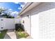 The side of the house shows the AC Unit next to a white fence, set against a blue sky at 13508 Greenleaf Dr, Tampa, FL 33613