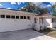 Charming brick home featuring a spacious two car garage and well-maintained front yard at 13508 Greenleaf Dr, Tampa, FL 33613