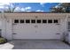 White garage door with decorative hardware and transom windows, offering ample parking space at 13508 Greenleaf Dr, Tampa, FL 33613