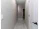 Hallway with light gray walls and marble tile flooring leads to other rooms at 13508 Greenleaf Dr, Tampa, FL 33613