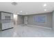 Spacious living room with bright tile flooring, recessed lighting, and an entrance leading to the home's entry door at 13508 Greenleaf Dr, Tampa, FL 33613