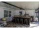 View of outdoor kitchen featuring granite countertops, seating, and stainless steel grill at 13508 Greenleaf Dr, Tampa, FL 33613