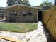 A view of the backyard featuring a stone walkway, a lawn, and a fence at 1372 S Hillcrest Ave, Clearwater, FL 33756