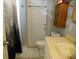 Functional bathroom with a sink, toilet, cabinet, and shower with curtain at 1372 S Hillcrest Ave, Clearwater, FL 33756